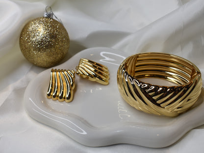 Gold fan-shaped earrings and matching cuff bangle. Front angle
