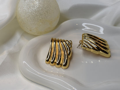 Gold fan-shaped earrings. Side angle.